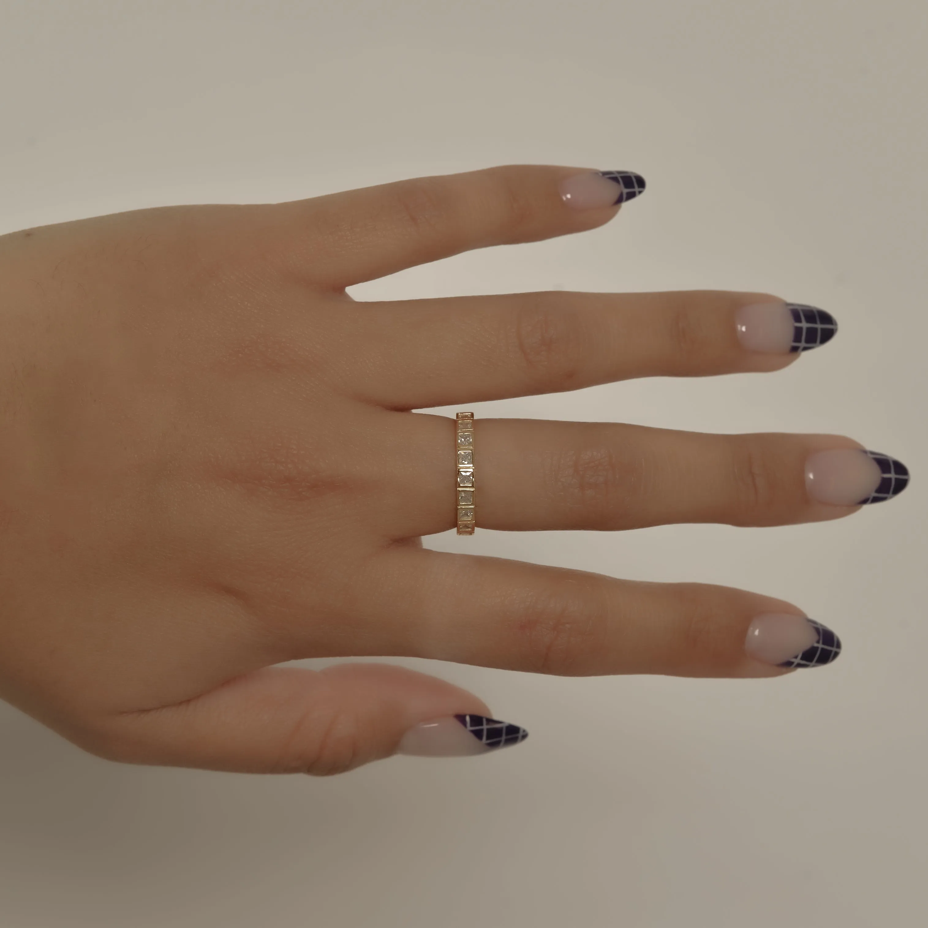 THE BEZELED PRINCESS CUT ETERNITY BAND